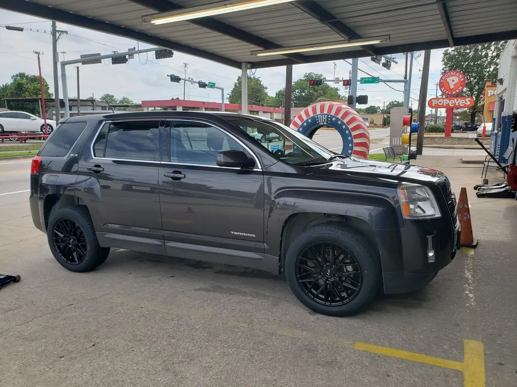 Customer GMC Terrain outside D H Tire with a new set of black aftermarket wheels fitted